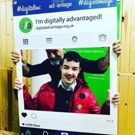 An image of a teenage with an older man holding a Instagram selfie frame that says I'm digitally advantaged on it