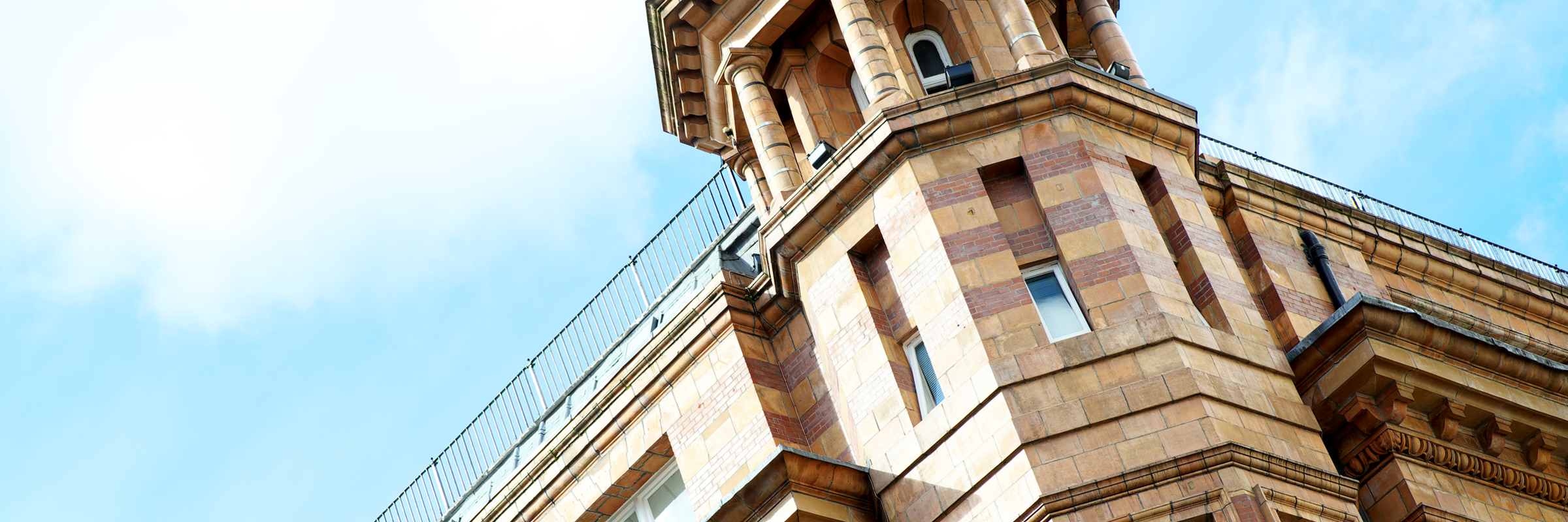 View looking up at Tootal Buildings - you can see a turret in front of blue sky