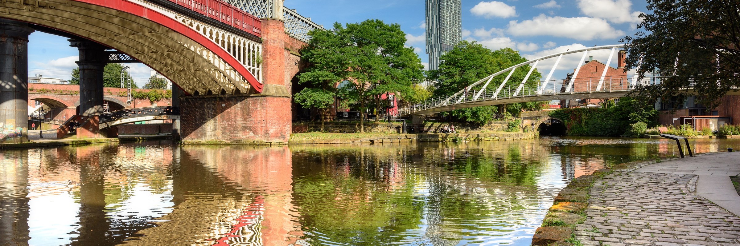 Greater Manchester canal and bridges with the Hilton Tower visible in the distance