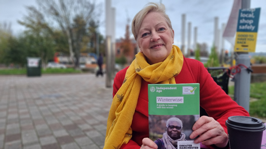 Older person holding the Winterwise booklet