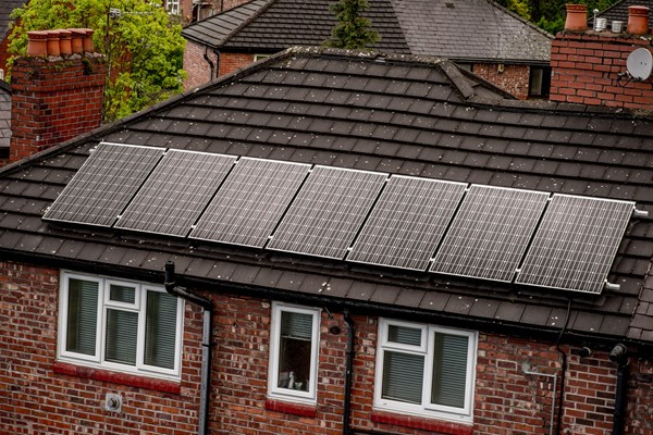 Solar panels on suburban redbrick house roof