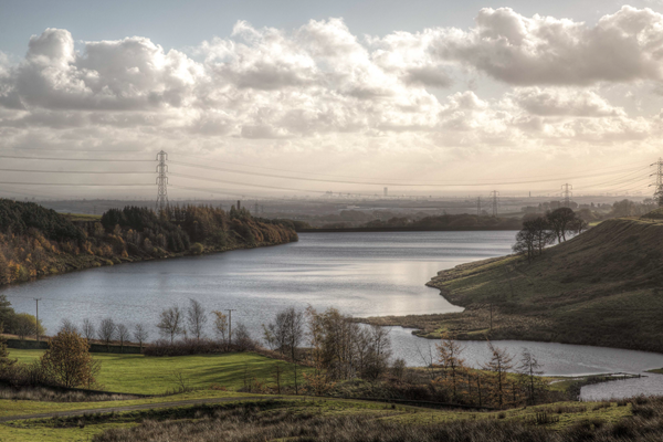 Picture of Greenbooth Reservoir showing water and surrounding land.