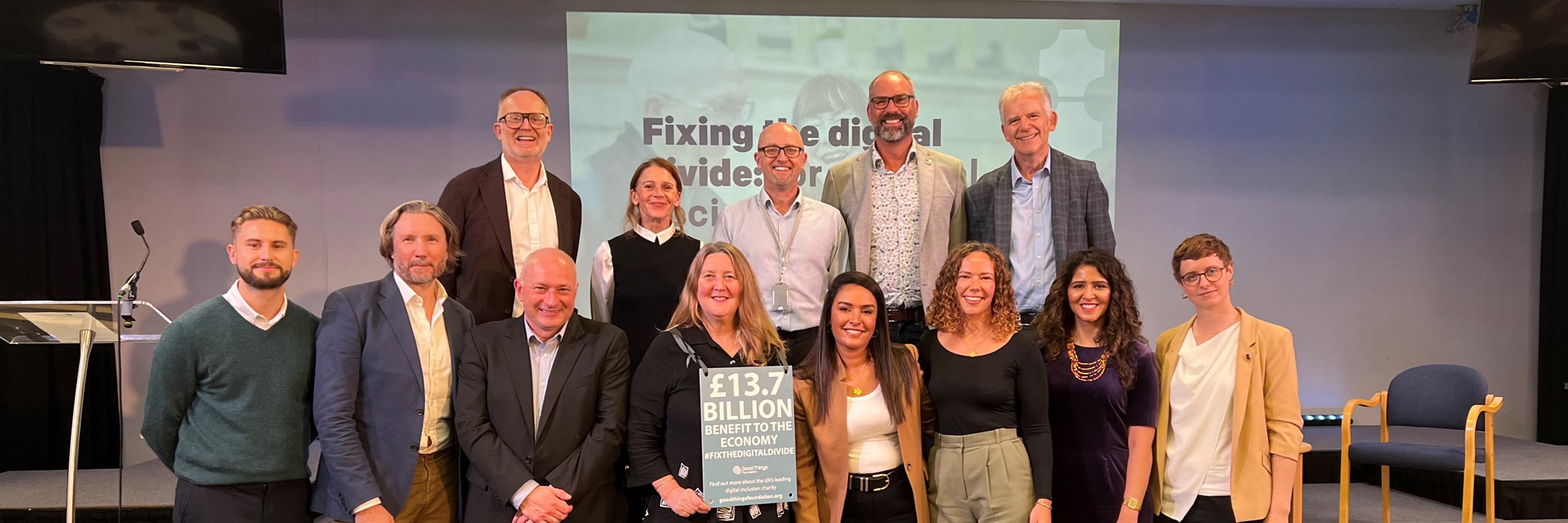 Group photo of a number of panellists from the Fixing the digital divide: for a digital society event, including (left to right) James Prowse - Hyperoptic, Nick Speed - BT, Professor Simeon Yates - University of Liverpool, Helen Milner - Good Things Foundation, Dana Haidan - Virgin Media,, Rachel Evans - Vodafone, Beena Puri - GMCA, Kat Dixon - Snook