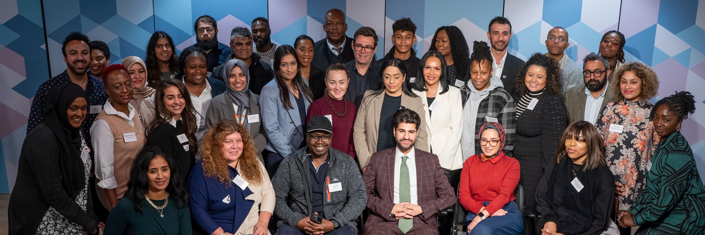 Diane Modahl MBE, Chair of the GM Civic and Community Leadership Programme Steering Group, Cllr Arooj Shah, and Mayor of Greater Manchester Andy Burnham, with participants of the Civic Leadership Programme in Greater Manchester 2023