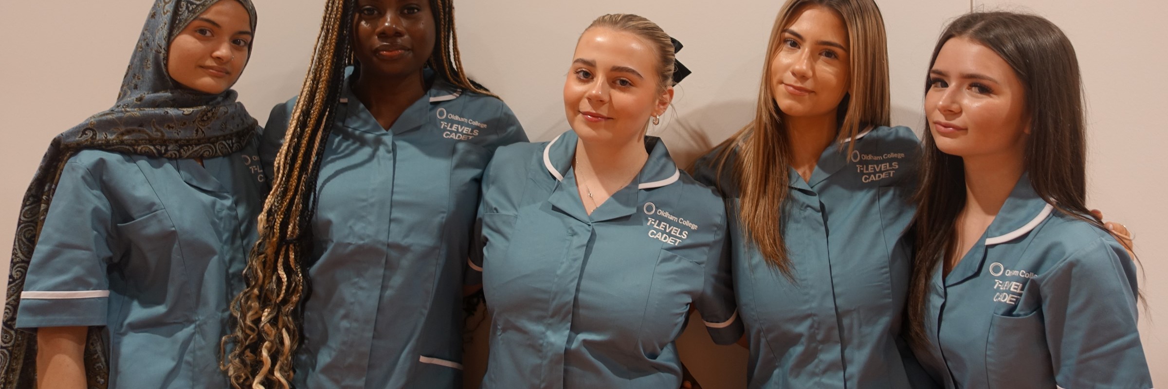Image of five people dressed in NHS uniforms