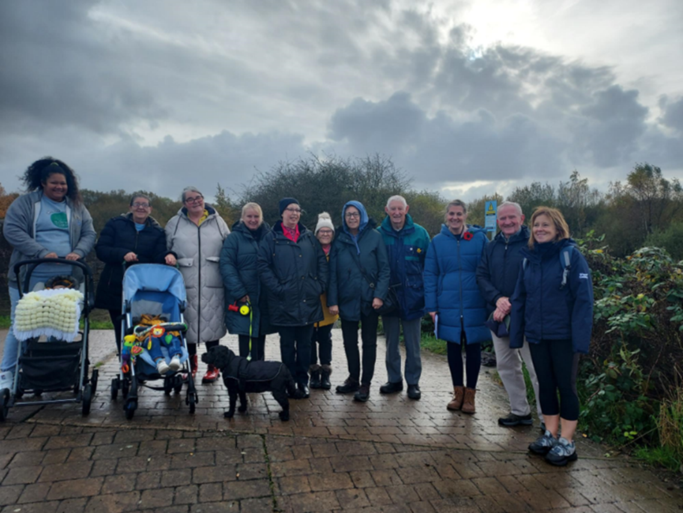 A group of older people dressed in warm clothes outside.